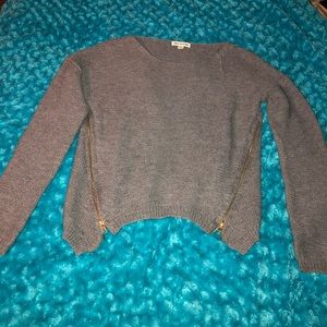 Gray kitted sweater with zippers down the side